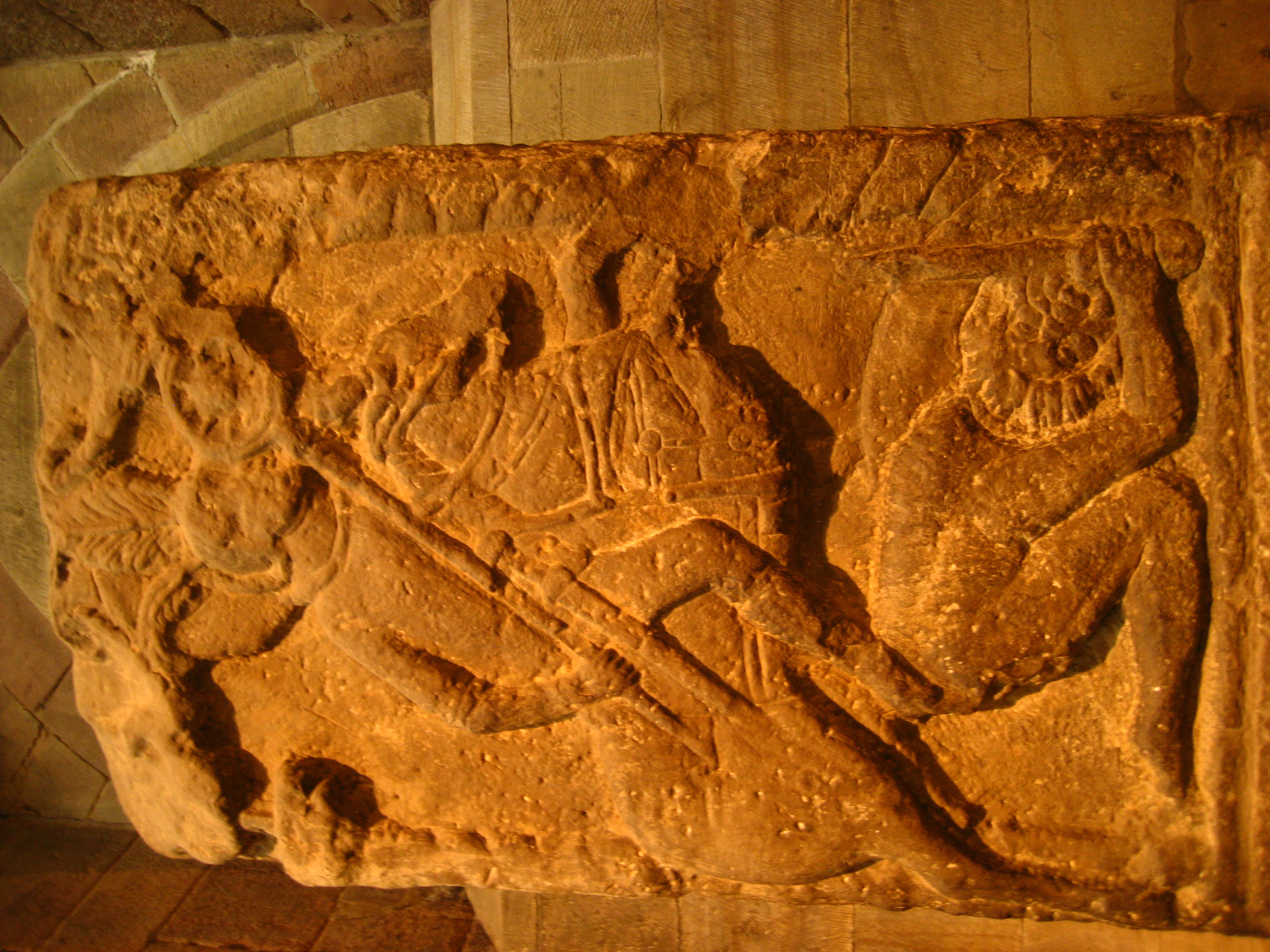 Stone bas relief of horseman trampling someone underfoot